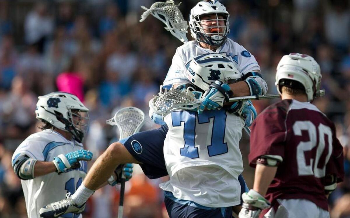 
North Carolina’s Jim Bitter (4) jumps into the arms of teammate Zach Powers (77) after Powers scored in the second period against Colgate during the NCAA Lacrosse Tournament on Sunday, May 10, 2015 in Chapel Hill, N.C. The Tar Heels rolled to a 19-12 victory.
