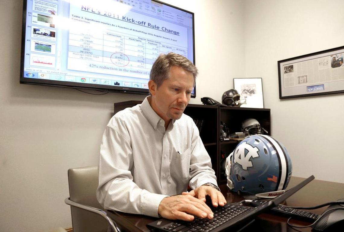 In this photo taken Wednesday, May 13, 2015 Kevin Guskiewicz, professor and former chair of the Department of Exercise and Sports Medicine at the College of Arts and Sciences, conducts research on helmet sensors at the University of North Carolina in Chapel Hill, N.C.