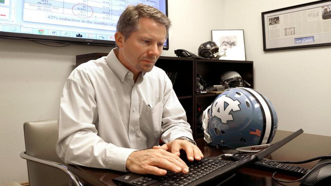 In this photo taken Wednesday, May 13, 2015 Kevin Guskiewicz, professor and former chair of the Department of Exercise and Sports Medicine at the College of Arts and Sciences, conducts research on helmet sensors at the University of North Carolina in Chapel Hill, N.C. 