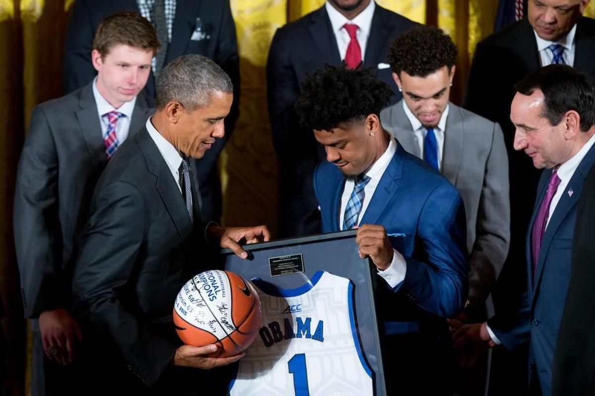 Duke’s Quinn Cook, center right, accompanied by coach Mike Krzyzewski, right, presents President Barack Obama a signed basketball and jersey in 2005 during the team’s visit to the White House to be recognized for winning the 2015 national championship.