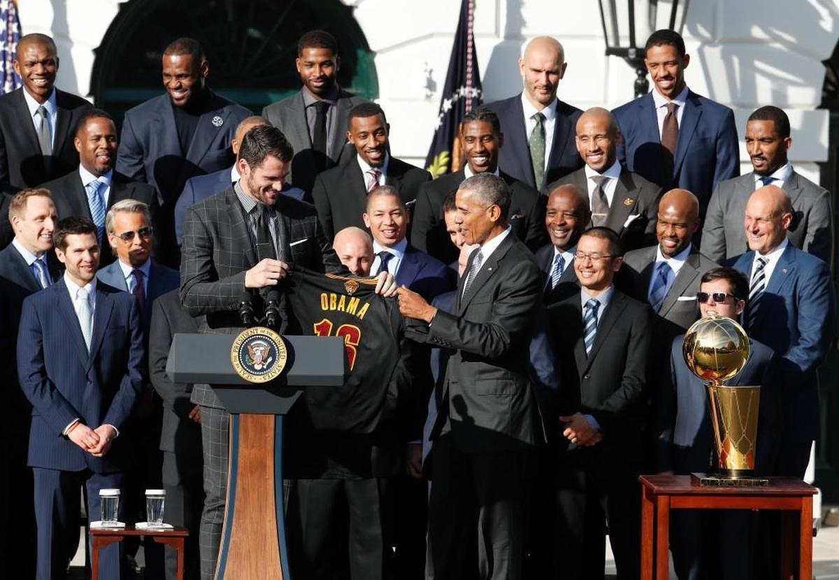 President Barack Obama accepts a team basketball jersey from the Cleveland Cavaliers Kevin Love, left, in Nov. 2016.
