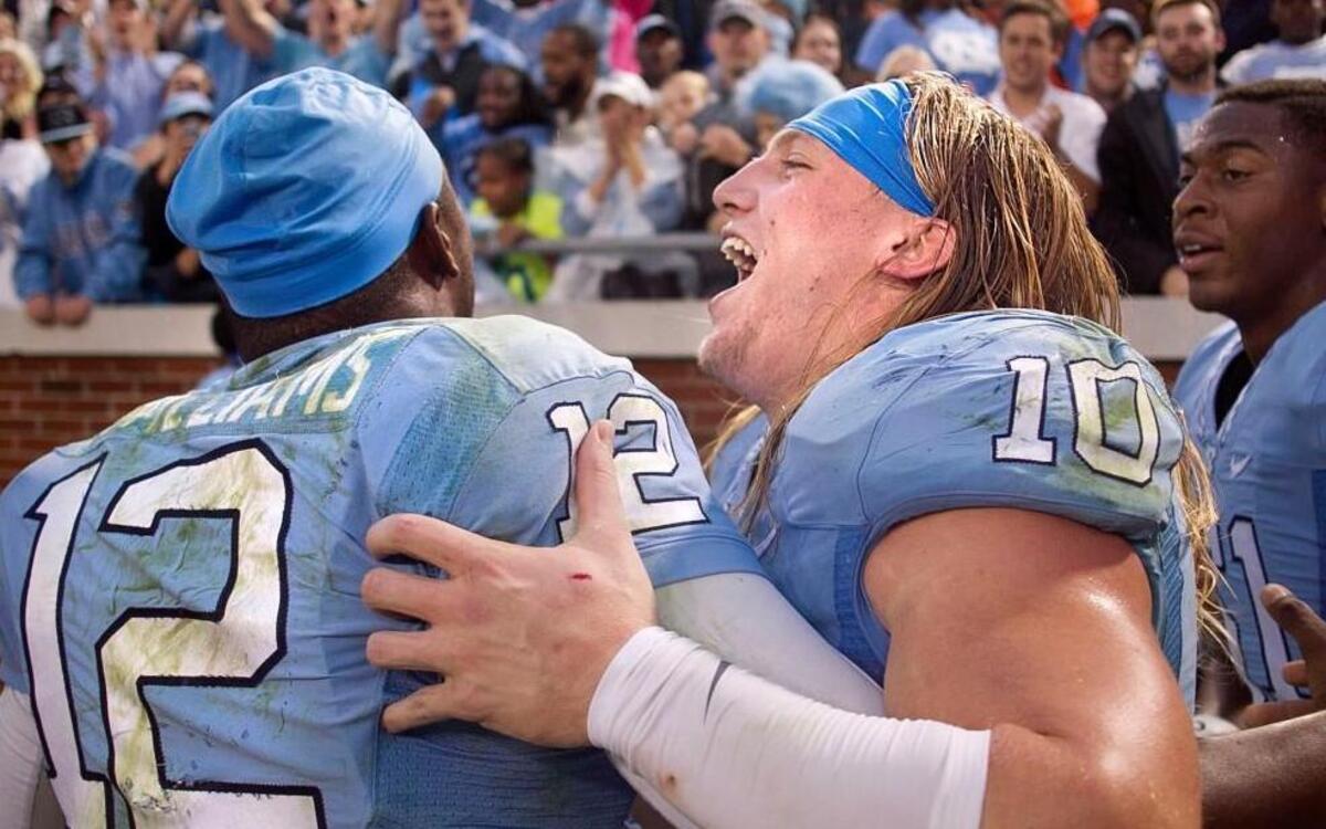 North Carolina’s Jeff Schoettmer (10) and quarterback Marquise Williams (12) celebrate the Tar Heels 38-31 victory over Georgia Tech with fans on Saturday, October 3, 2015 in Atlanta, Georgia.