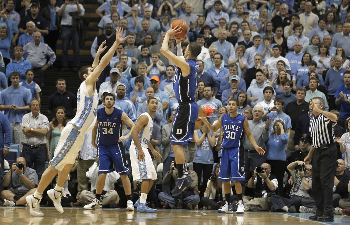 Duke guard Austin Rivers launches a 3-pointer as UNC forward Tyler Zeller, left, attempts to defend in the Blue Devils’ 85-84 buzzer-beater win over the Tar Heels on Feb. 8, 2012.