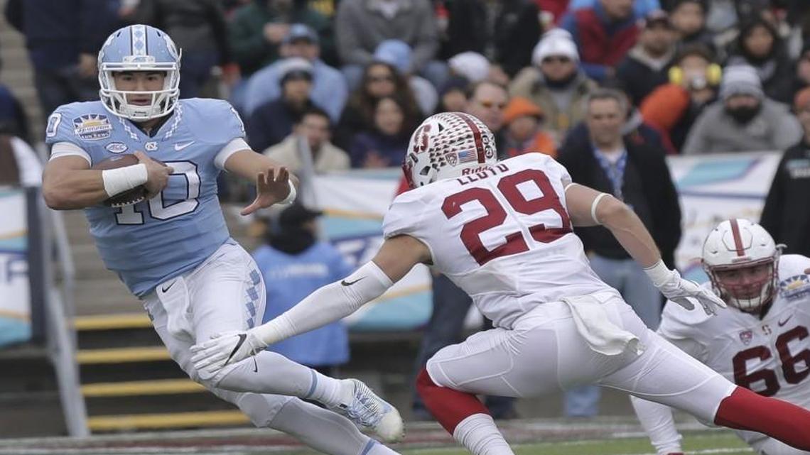 North Carolina quarterback Mitch Trubisky tries to get past Stanford safety Dallas Lloyd in the second quarter of the Sun Bowl in El Paso.