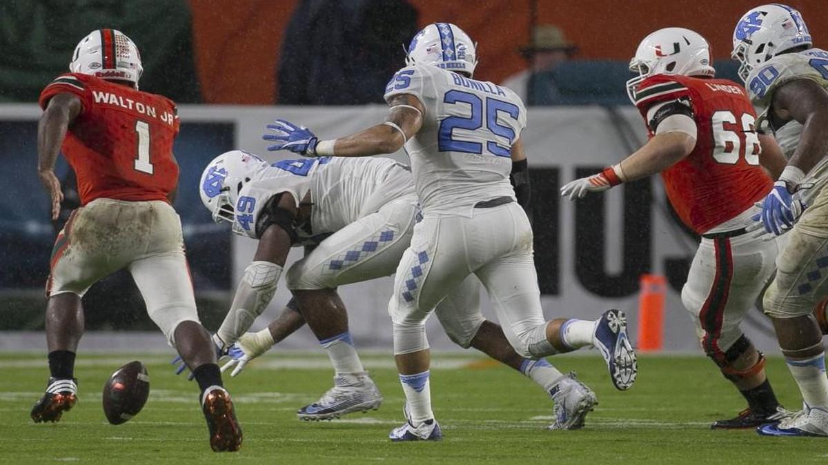 North Carolina defensive tackle Jeremiah Clarke (49) recovers a Miami fumble to secure the Tar Heels’ 20-13 victory.