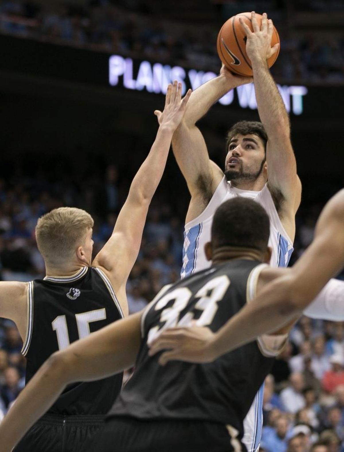 North Carolina’s Luke Maye (32) shoots over Wofford’s Trevor Stumpe (15) during the first half on Wednesday, December 20, 2017 at the Smith Center in Chapel Hill, N.C.