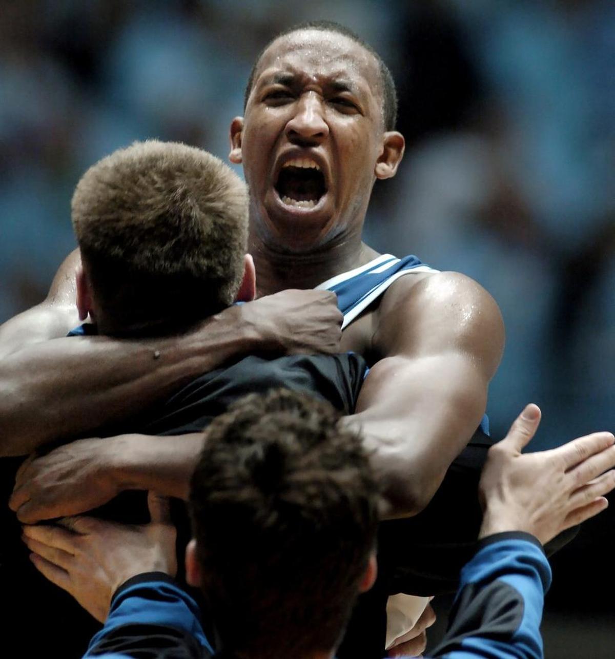 Duke’s Chris Duhon is lifted up by teammate Lee Melchionni after Duhon scored a game-winning basket in overtime against UNC on Feb. 5, 2004.