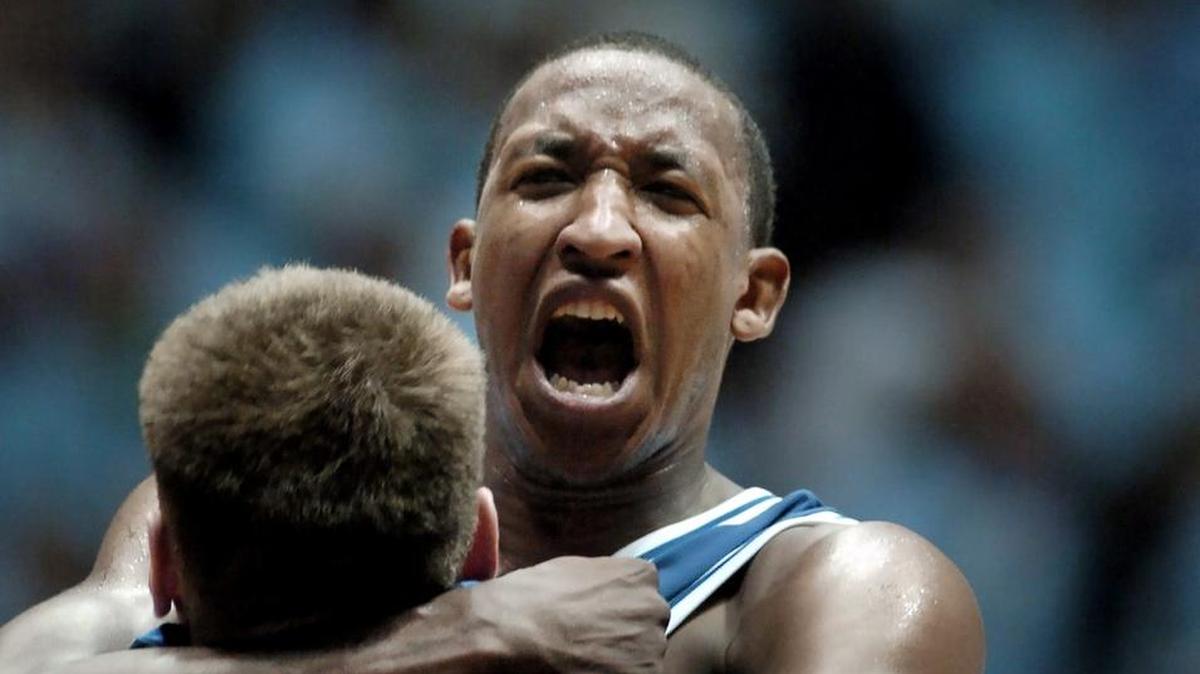 Duke’s Chris Duhon is lifted up by teammate Lee Melchionni after Duhon scored a game-winning basket in overtime against UNC on Feb. 5, 2004.