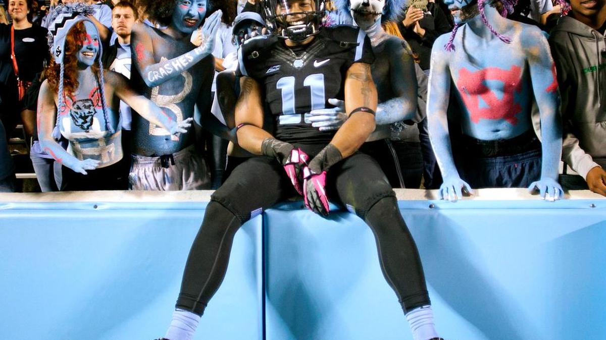 
UNC quarterback Malik Simmons (11) celebrates the Tar Heels' 48-43 victory over Georgia Tech with fans in the Tar Pit on Saturday, October 18, 2014 at Kenan Stadium in Chapel Hill, N.C.
