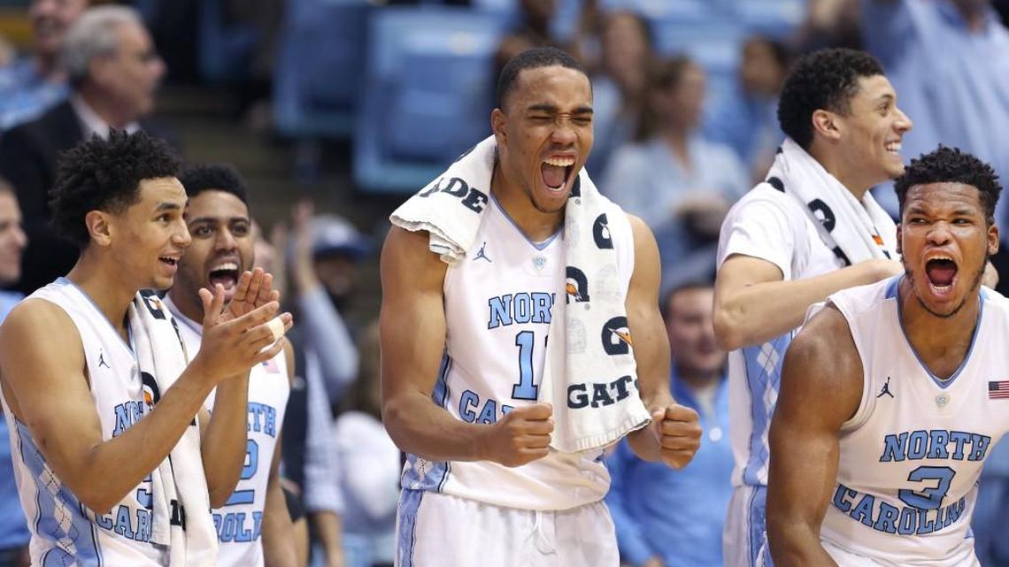 North Carolina's Marcus Paige (5), Brice Johnson (11) and Kennedy Meeks (3) celebrates a late basket by a reserve player Spenser Dalton in the Tar Heel’s 98-65 win over Davidson on Sunday, December 6, 2015 at the Smith Center in Chapel Hill, N.C.