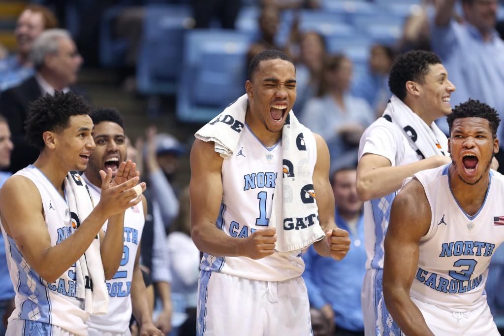 North Carolina's Marcus Paige (5), Brice Johnson (11) and Kennedy Meeks (3) celebrates a late basket by a reserve player Spenser Dalton in the Tar Heel’s 98-65 win over Davidson on Sunday, December 6, 2015 at the Smith Center in Chapel Hill, N.C.