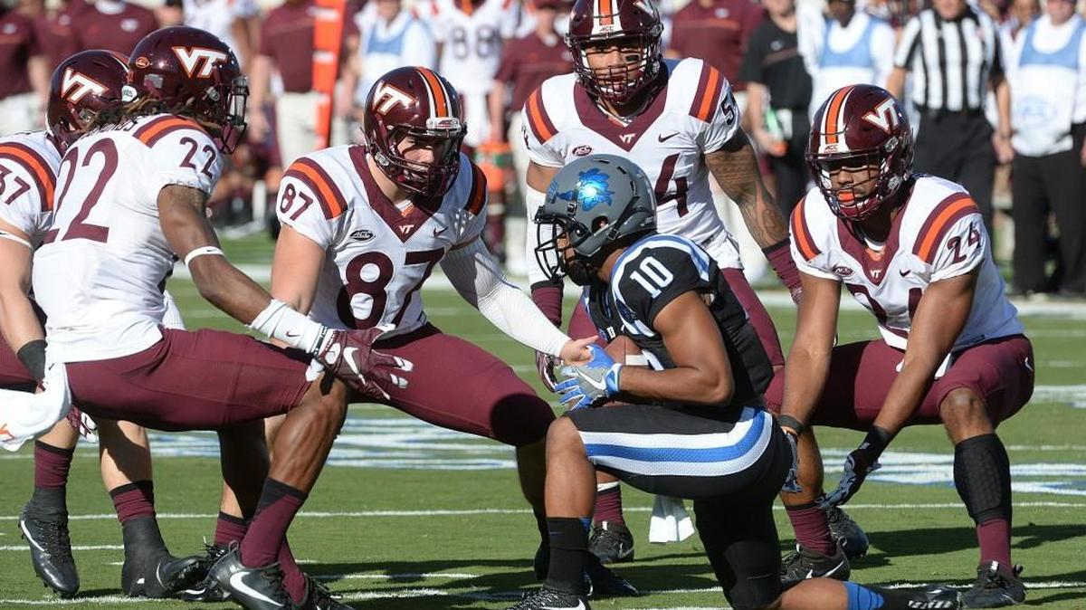 Duke wide receiver Ryan Smith (10) is surrounded by Hokies after calling for a fair catch on a punt during the first quarter. Virginia Tech beat the Blue Devils 24-21 at Wallace Wade Stadium Saturday.