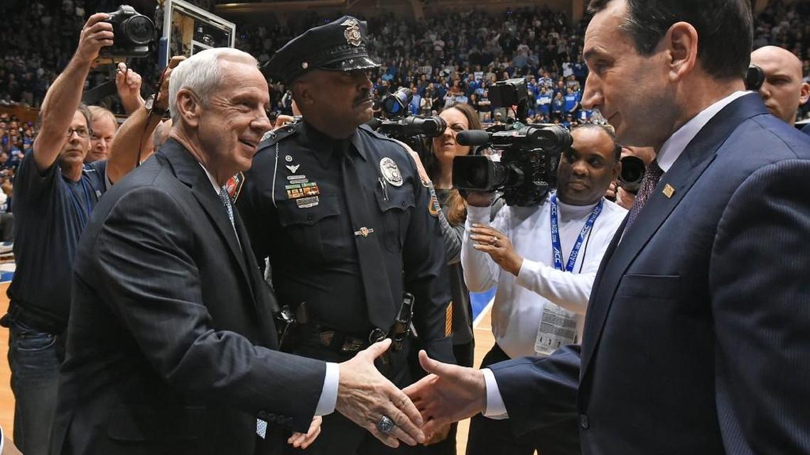 UNC coach Roy Williams, left, and Duke coach Mike Krzyzewski greet each other prior to the start of the game between the Blue Devils and the Tar Heels on March 5, 2016.