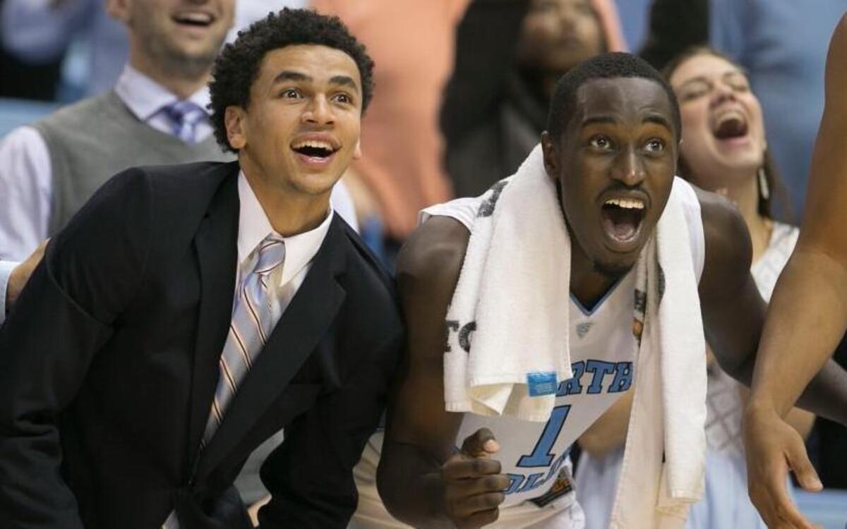 North Carolina's Marcus Paige and Theo Pinson (1) watch teammate Kanler Coker (13) miss at the free throw line with 15 seconds to play, preventing the Tar Heels from scoring 100 points in their exhibition game against Guilford on Friday, November 6, 2015 at the Smith Center in Chapel Hill, N.C. The Tar Heels rolled to a 99-49 victory. Paige did not play, he is out with a broken hand.