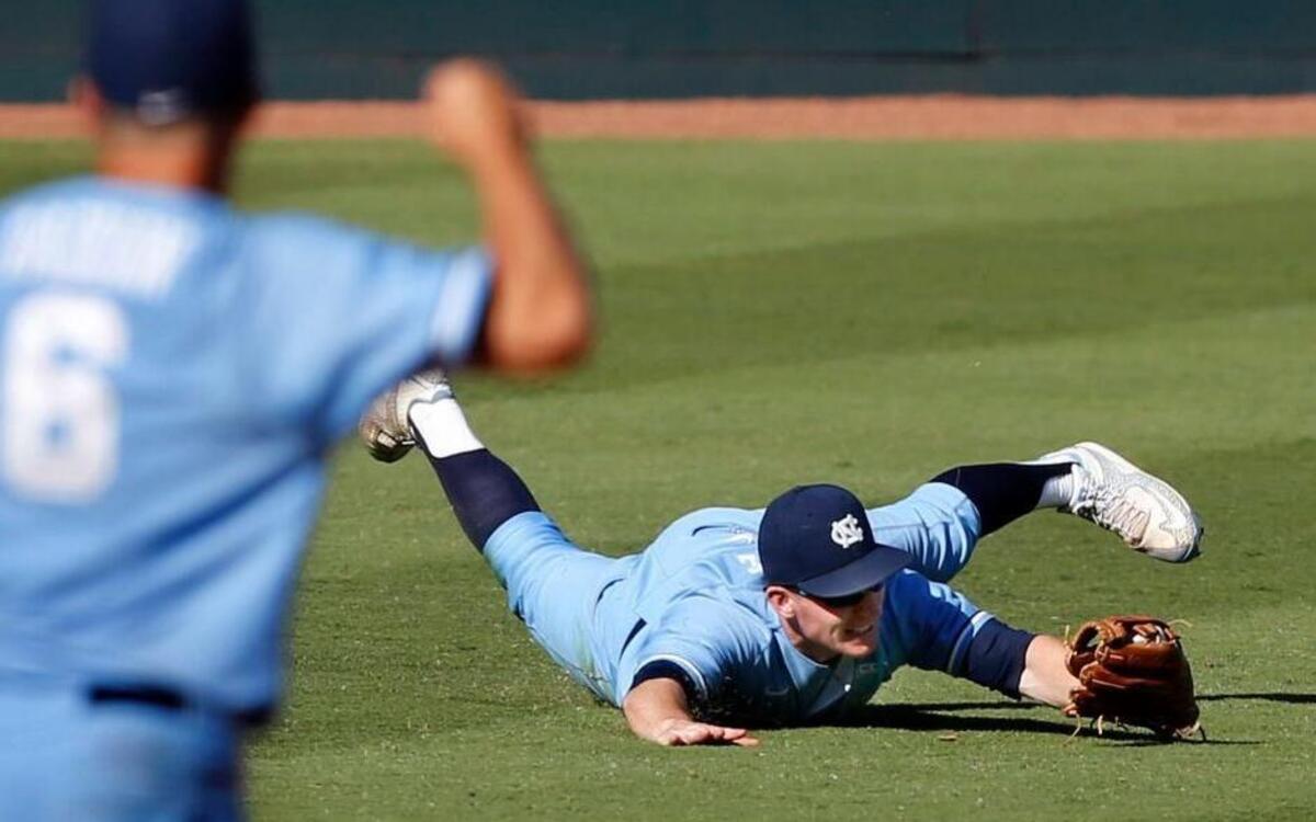
North Carolina's Adam Pate (2) makes a diving catch of a ball hit by Clemson's Tyler Slaton (18) in the seventh inning during UNC's 6-3 victory over Clemson in the ACC Baseball Tournament at the Durham Bulls Athletic Park in Durham, N.C., Friday, May 22, 2015.
