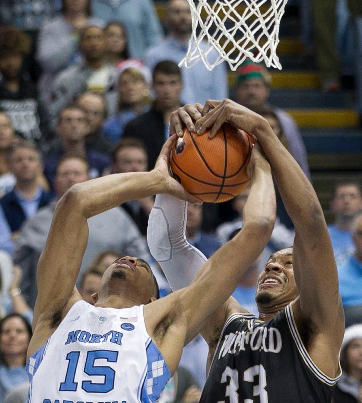 Wofford’s Cameron Jackson (33) blocks a shot by North Carolina’s Garrison Brooks (15) during the closing minute of play on Wednesday, December 20, 2017 at the Smith Center in Chapel Hill, N.C.