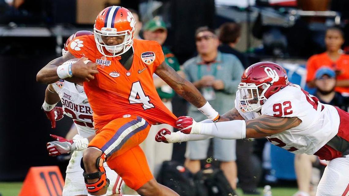 Clemson quarterback Deshaun Watson (4) runs with the ball as Oklahoma defensive tackle Matthew Romar (92) attempts to stop him, during the first half of the Orange Bowl.