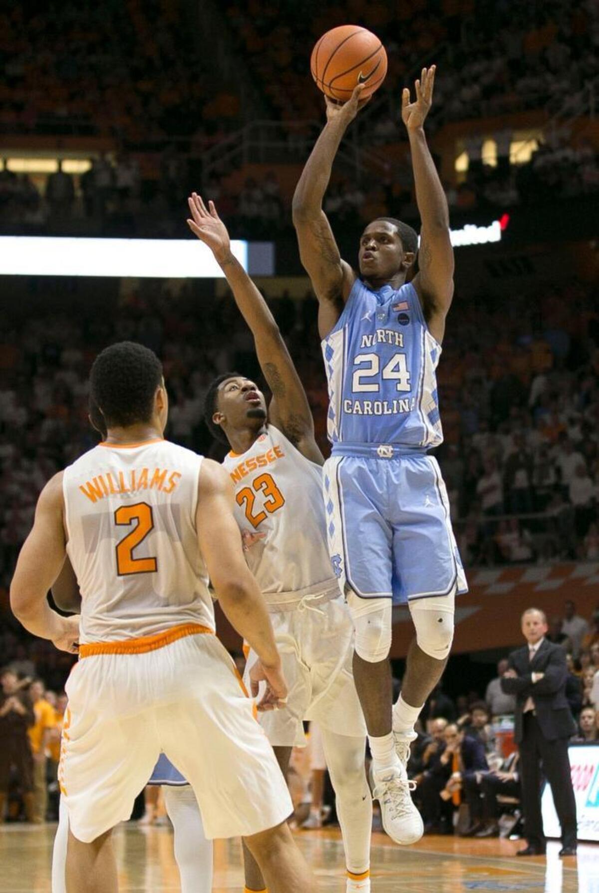 North Carolina’s Kenny Williams (24) launches a three-point shot over Tennessee’s Jordan Bowden (23) with :35 seconds to play to give the Tar Heels’ a 72-70 lead on Sunday, December 17, 2017 at Thompson-Boling Arena in Knoxville, Tenn. North Carolina went on to win 78-73.