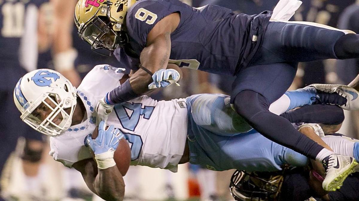 North Carolina tailback Elijah Hood (34) picks up 11 yards in the second quarter before being stopped by Pittsburgh's Jordan Whitehead (9) on Thursday, October 29, 2015 at Heinz Field in Pittsburgh, Pa.