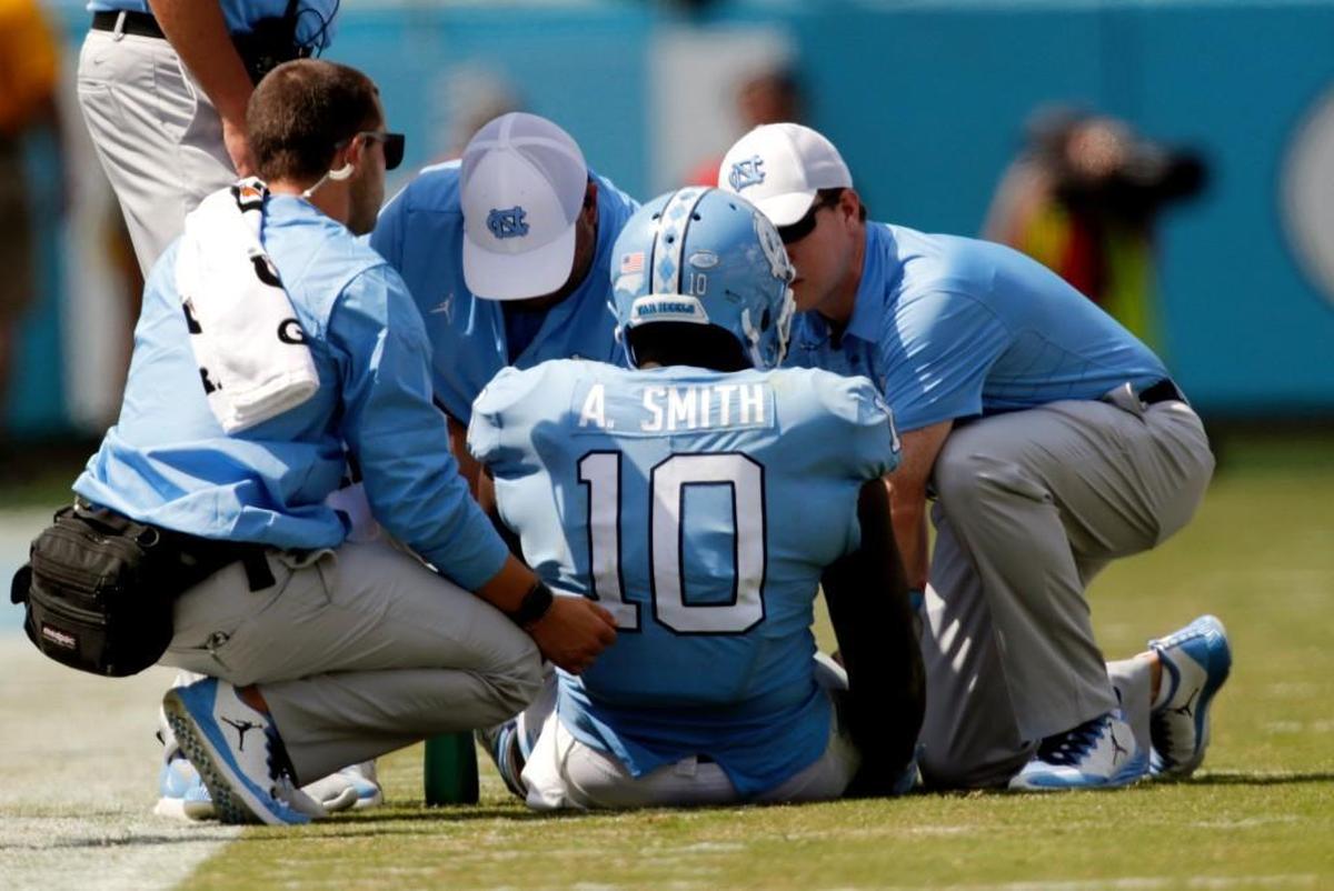 Trainers tend to UNC linebacker Andre Smith after he went down with an injury against Louisville on Sept. 9.