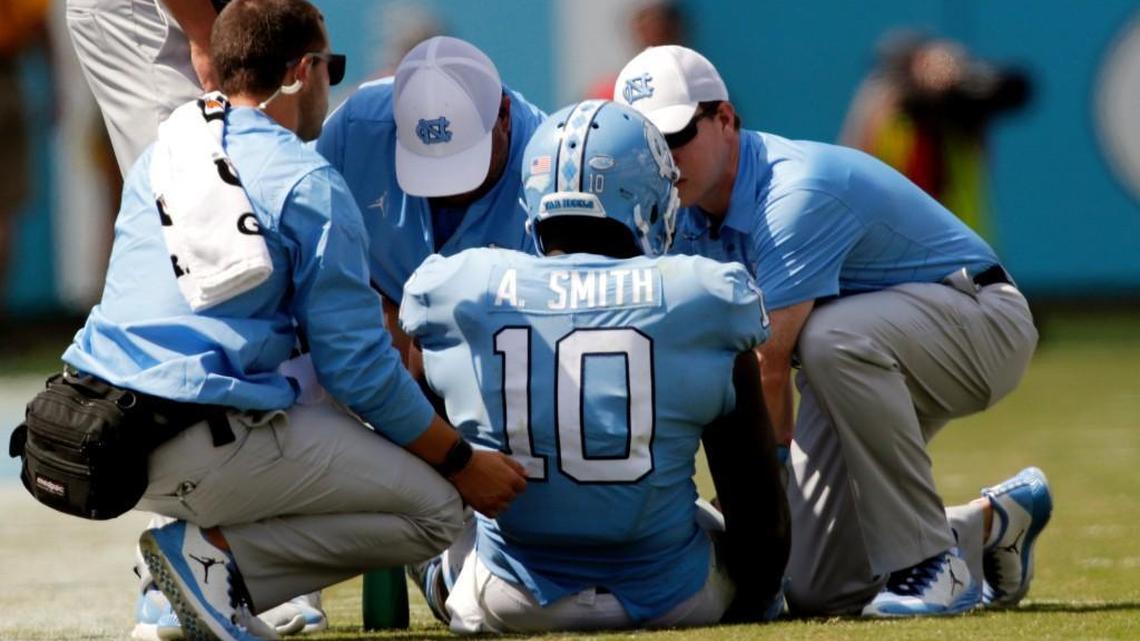 Trainers tend to UNC linebacker Andre Smith after he went down with an injury against Louisville on Sept. 9.