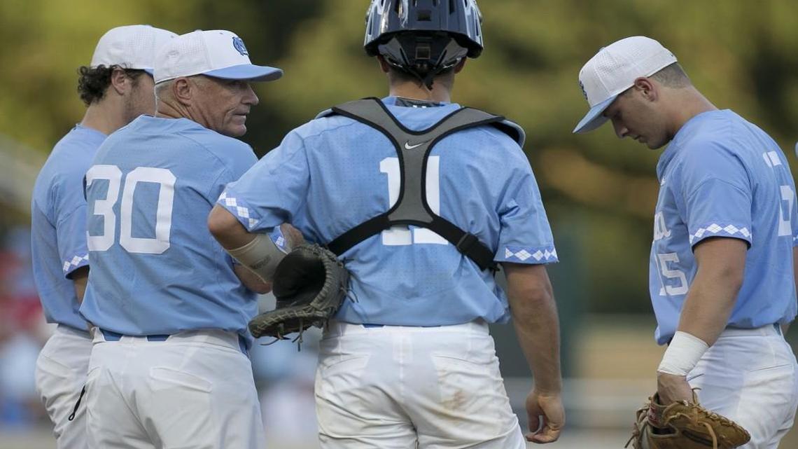 North Carolina coach Mike Fox confers with catcher Cody Roberts (11) and Michael Busch (15) after making a pitching change in the fifth inning against Davidson during their NCAA regional baseball game on Friday at Boshmaer Stadium in Chapel Hill.