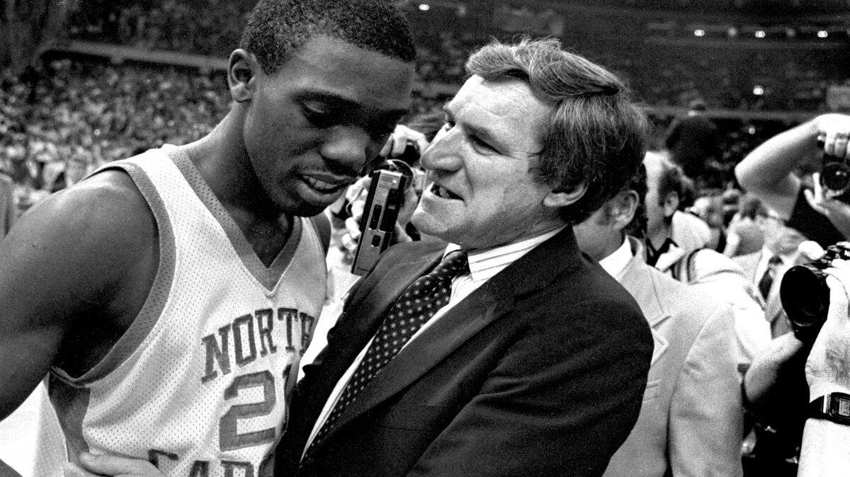 UNC coach Dean Smith congratulates point guard Jimmy Black after the Tar Heels defeated the Georgetown Hoyas to win the 1982 National Championship in New Orleans, April 7, 1982.