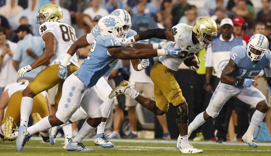 Notre Dame running back Josh Adams (33) breaks free from North Carolina defensive end Tomon Fox (12) to score on a 73-yard touchdown run during the first half of UNC's game against Notre Dame at Kenan Stadium in Chapel Hill, NC Saturday, Oct. 7, 2017.