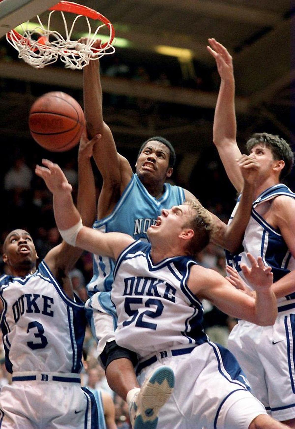 Rasheed Wallace dunks over Duke’s Ricky Price, left, Erik Meek, middle, and Cherokee Parks, right, on Feb. 2, 1995.
