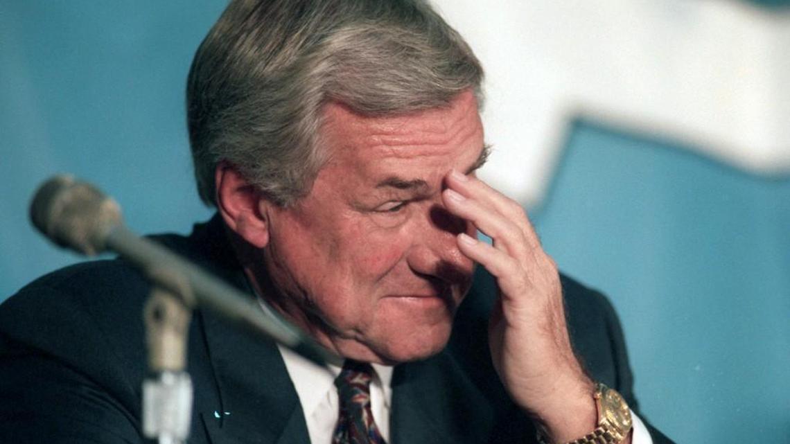 Dean Smith wipes away a tear during an emotional moment in the press conference announcing his resignation as head basketball coach at UNC.