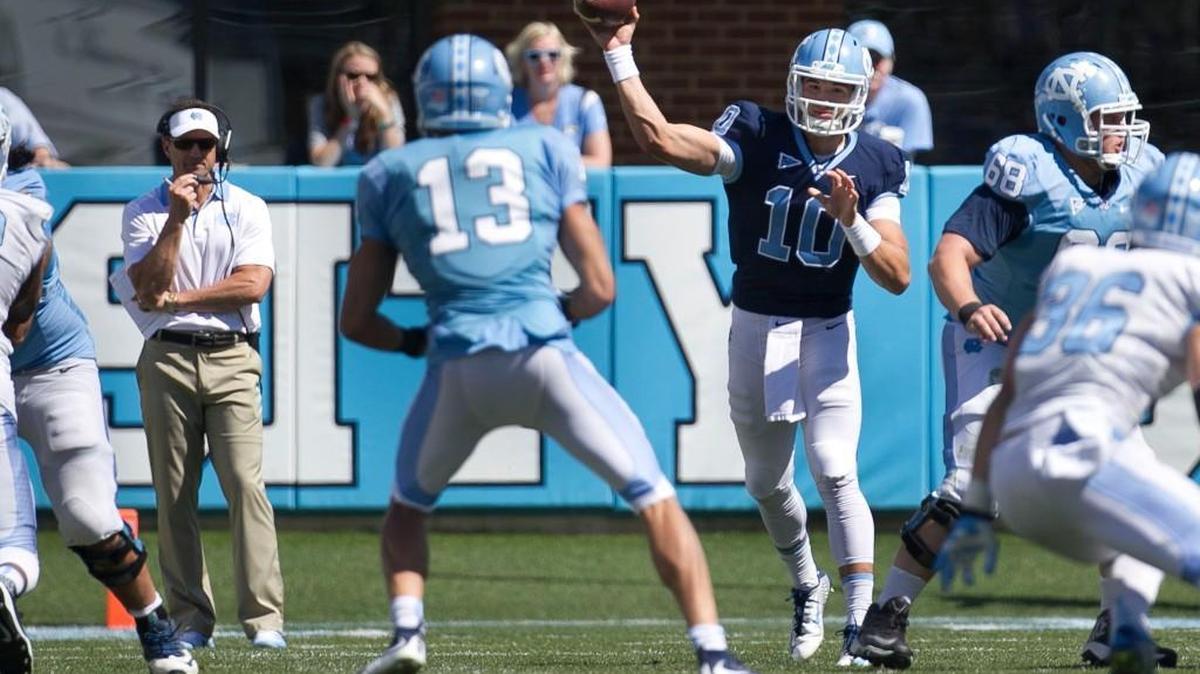 North Carolina quarterback Mitch Trubisky (10) connects with receiver Mack Hollins (13) under the watchful eye of head coach Larry Fedora during the Tar Heels’ Spring Game on April 16 at Kenan Stadium.