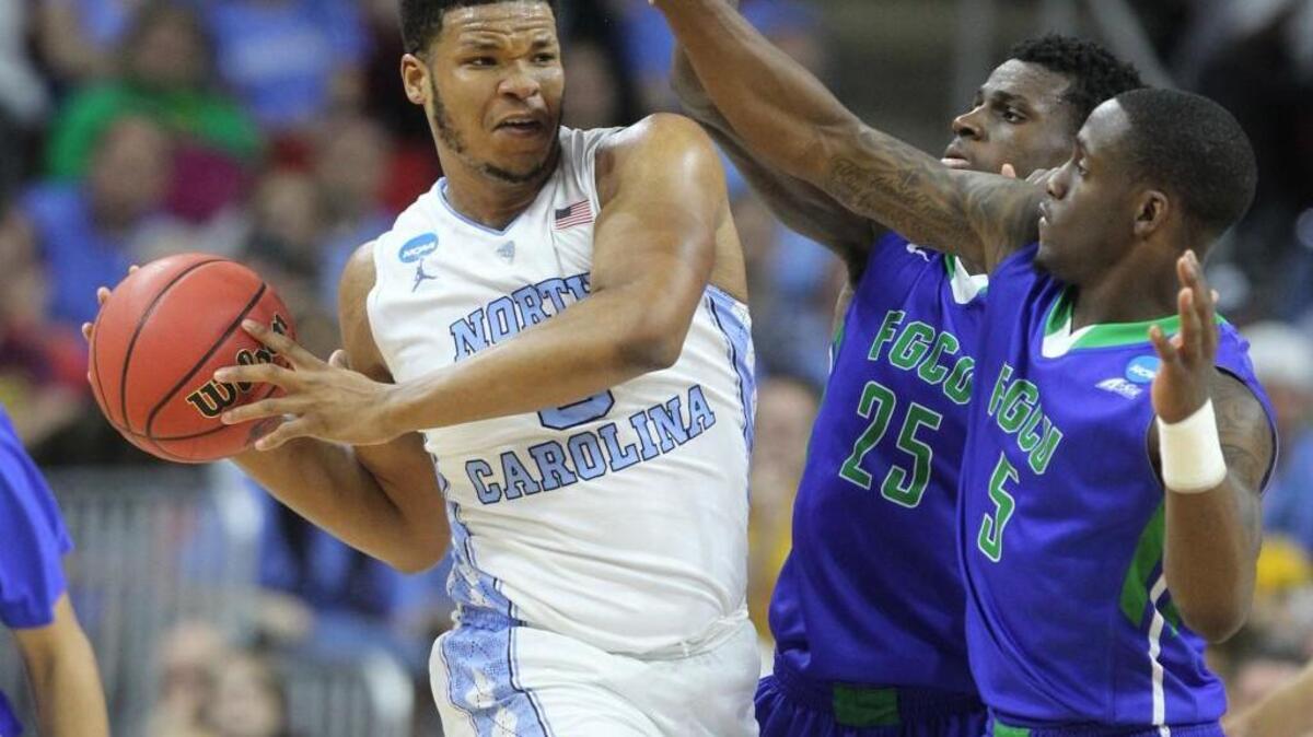 North Carolina's Kennedy Meeks (3) keeps the ball from Florida Gulf Coast's Marc Eddy Norelia (25) and Zach Johnson (5) during the second half in the first round of the NCAA Tournament at PNC Arena in Raleigh, N.C., on March 17, 2016. North Carolina advanced, 83-67.