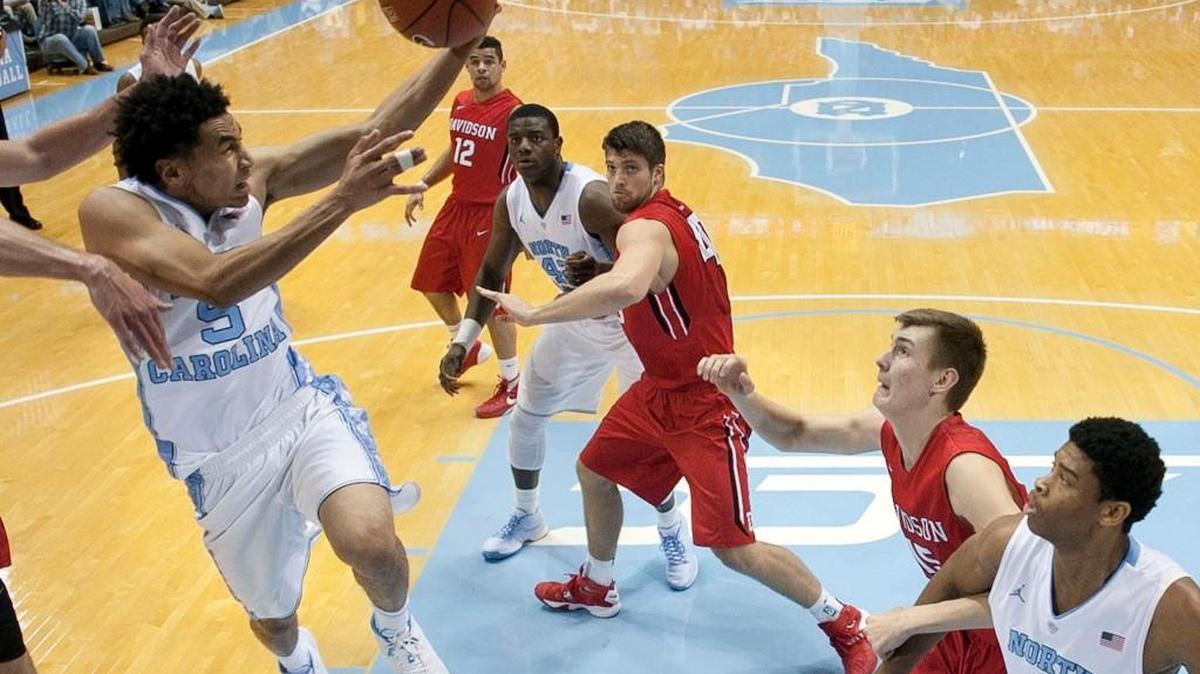 North Carolina’s Marcus Paige (5) drives to the basket between Davidson defenders Oskar Michelsen (15) and Andrew McAuliffe (40) during the first half on Sunday at the Smith Center in Chapel Hill. Paige scored 13 points in the Tar Heels’ 98-65 victory.