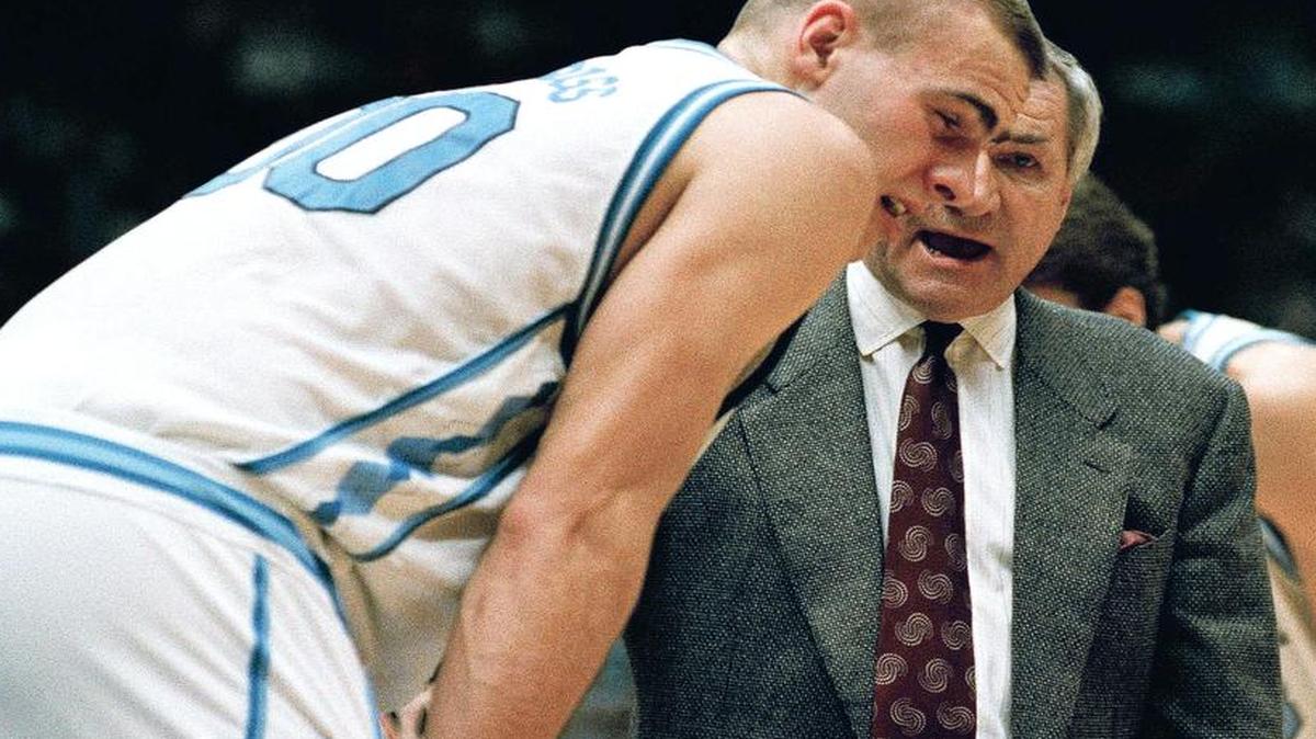 
North Carolina coach Dean Smith has a word with Eric Montross after Montross was poked in the eye during the NCAA East Regional Championship game against Cincinnati on March 28, 1993. The Tarheels advanced to the Final Four with their 75-68 win. 
