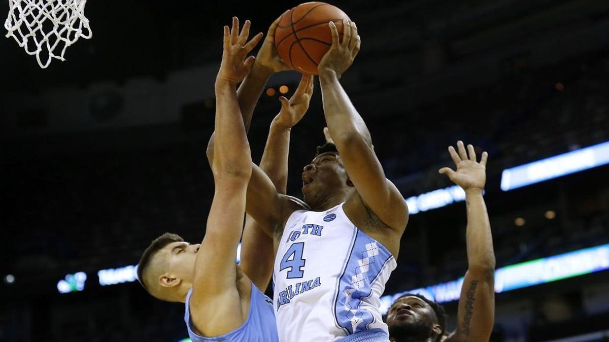 UNC’s Isaiah Hicks shoots over Tulane’s Malik Morgan and Ryan Smith during the first half at the Smoothie King Center in New Orleans.