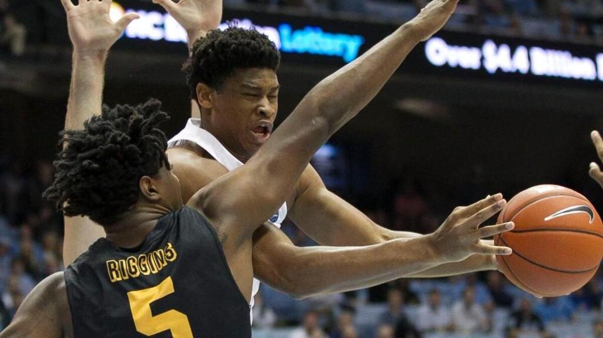 North Carolinas Isaiah Hicks (4) drives against Long Beach State’s Mason Riggins (5) on November 15 at the Smith Center.