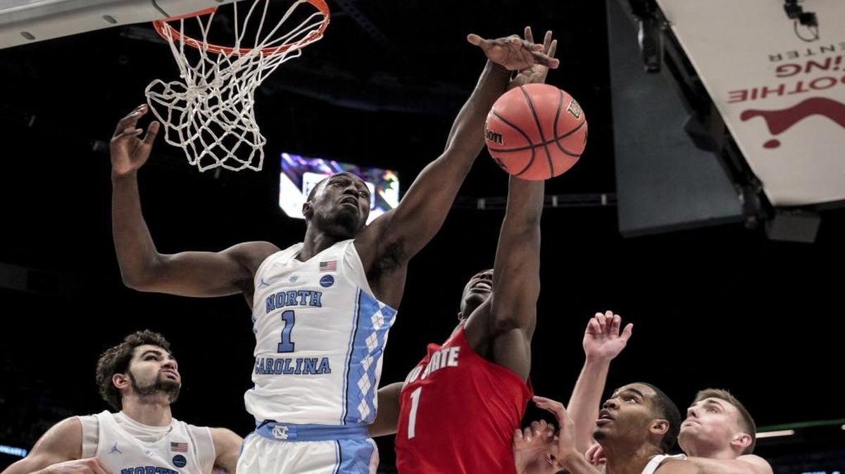 North Carolina forward Theo Pinson (1) and Ohio State forward Jae'Sean Tate (1) battle for a rebound in the first half of an NCAA basketball game in New Orleans, Saturday, Dec. 23, 2017. (AP Photo/Scott Threlkeld)