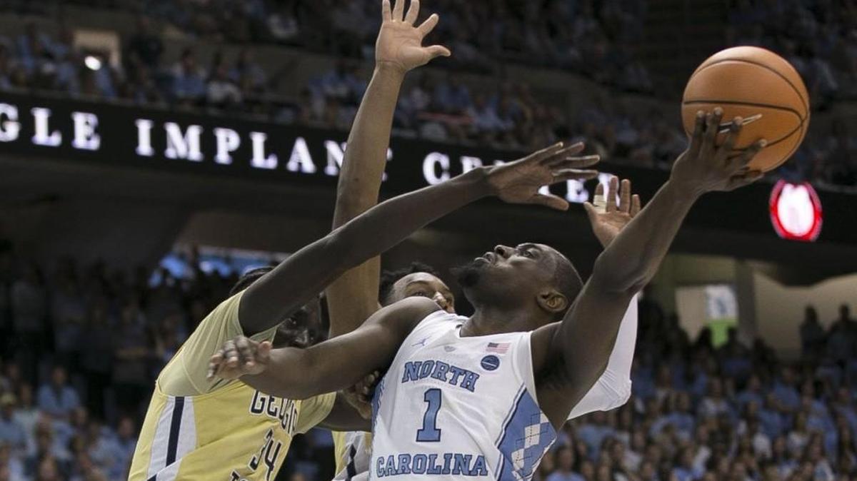 North Carolina’s Theo Pinson (1) drives to the basket past Georgia Tech’s Abdoulaye Gueye (34) and Josh Okogie (5) during the second half on Saturday, January 20, 2018 at the Smith Center in Chapel Hill, N.C. Pinson scored ten points and secured 11 rebounds in the Tar Heels’ 80-66 victory.