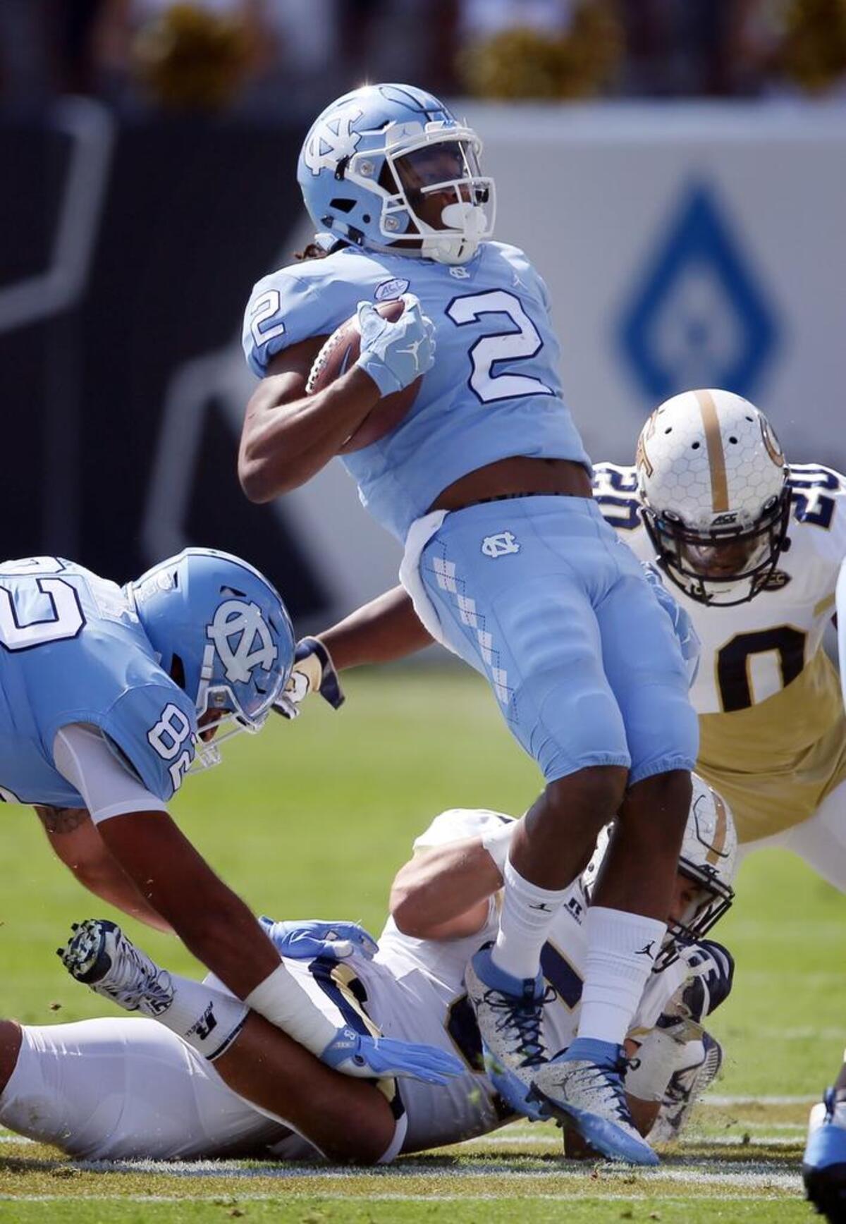 North Carolina running back Jordon Brown (2) is tackled by Georgia Tech linebacker Brant Mitchell (51) and Georgia Tech defensive back Lawrence Austin (20).
