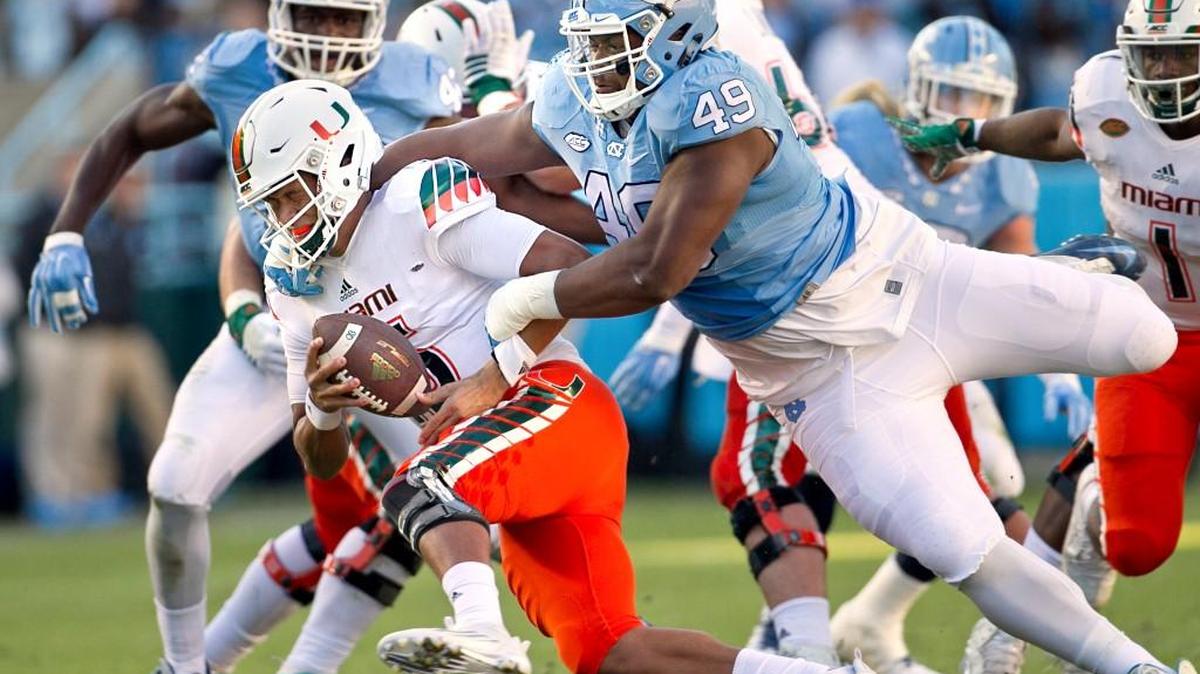 North Carolina’s Jeremiah Clarke (49) sacks Miami quarterback Brad Kaaya (15) during their game in November 2015 at Kenan Stadium in Chapel Hill.