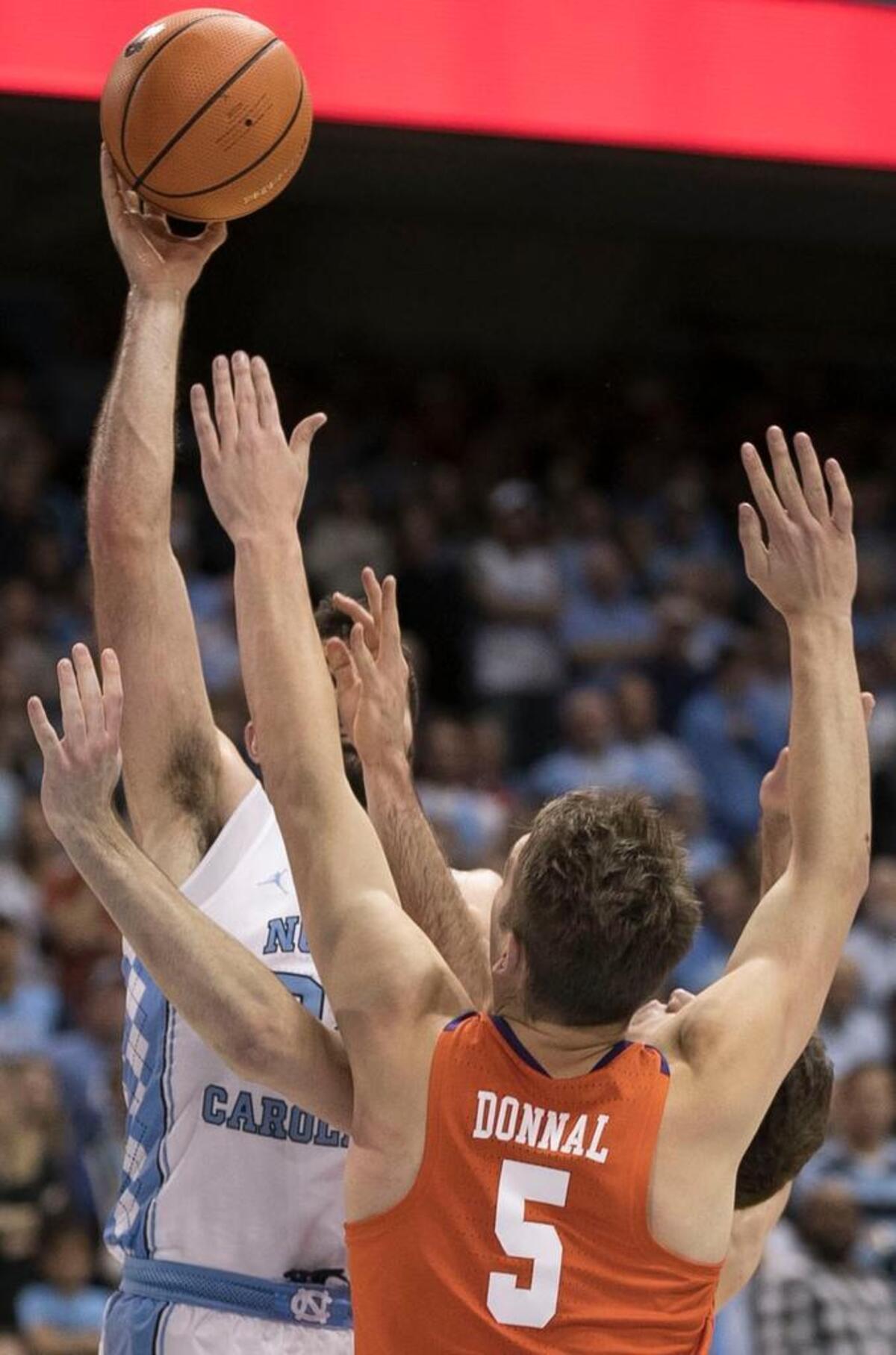North Carolina’s Luke Maye (32) puts up a shot over Clemson’s Mark Donnal (5) and David Skara (24) during the second half against Clemson on Tuesday, January 16, 2018 at the Smith Center in Chapel Hill, N.C.