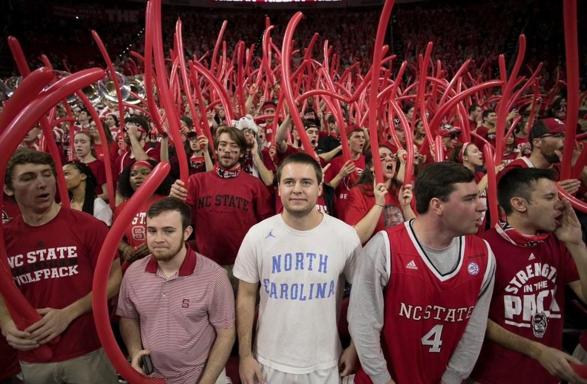 N.C. State junior Casey Davison of Raleigh, shows his support for the Tar Heels in a sea of red, prior to the tip-off of the game in Raleigh.