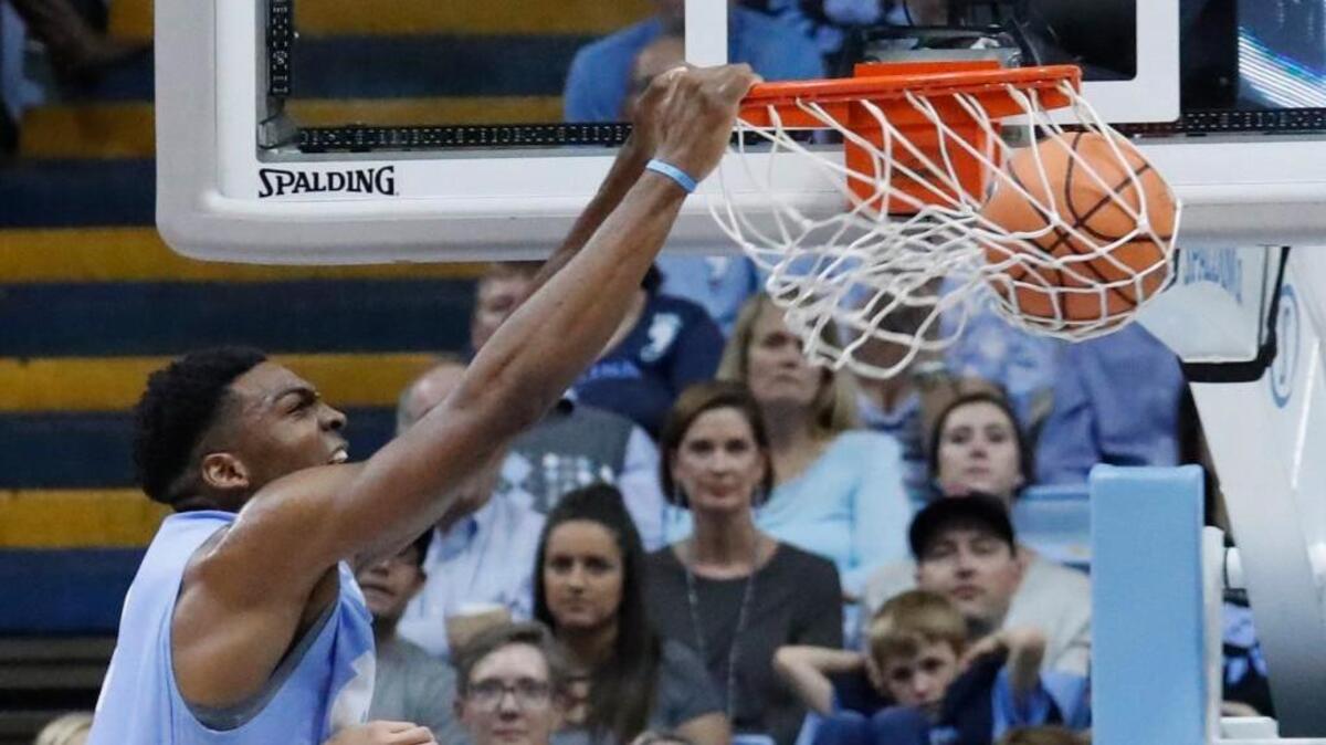 Brandon Huffman (42) slam dunks the ball during a scrimmage as the UNC Tar Heel basketball team has its annual "Late Night with Roy" event to open the college basketball season at the Dean Smith Center in Chapel Hill on Oct. 13, 2017.