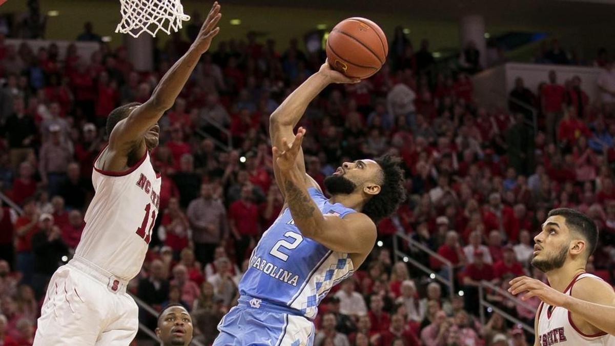 North Carolina’s Joel Berry II (2) drives to the basket against N.C. State’s Markell Johnson (11) during the second half on Saturday, February 10, 2018 at the PNC Arena in Raleigh, N.C.