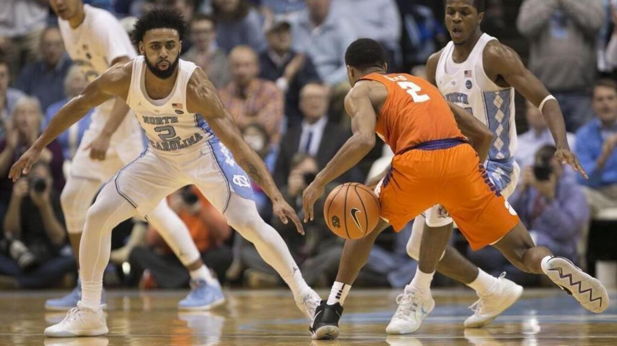 North Carolina’s Joel Berry (2) and Kenny Williams force a turnover by Clemson’s Marcquise Reed during the second half on Tuesday.