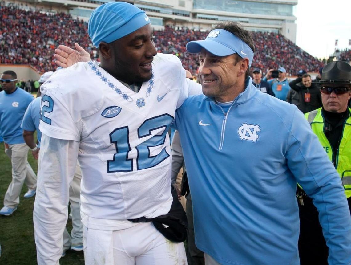 North Carolina coach Larry Fedora embraces quarterback Marquise Williams following the Tar Heels’ 30-27 overtime win over Virginia Tech in 2015.