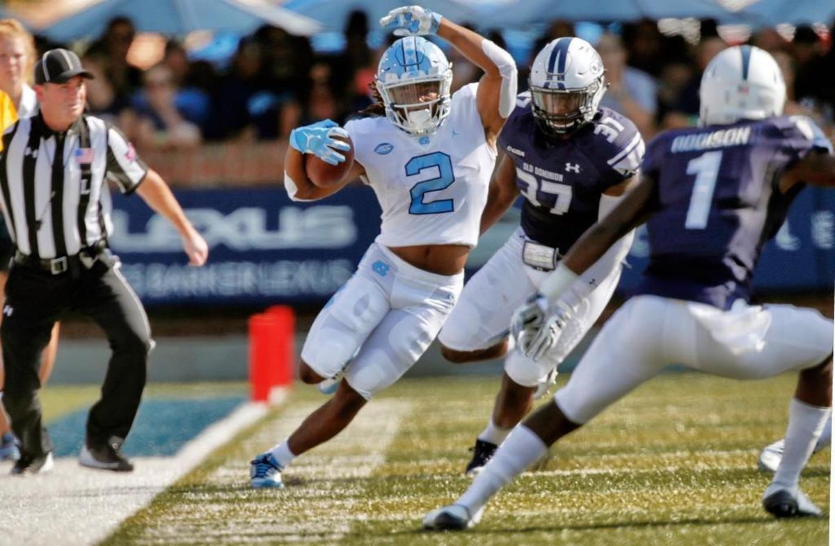 UNC's Jordon Brown (2) tries to stay in bounds and avoid ODU's Marvin Branch (37) and Brandon Addison (1) during the first quarter.