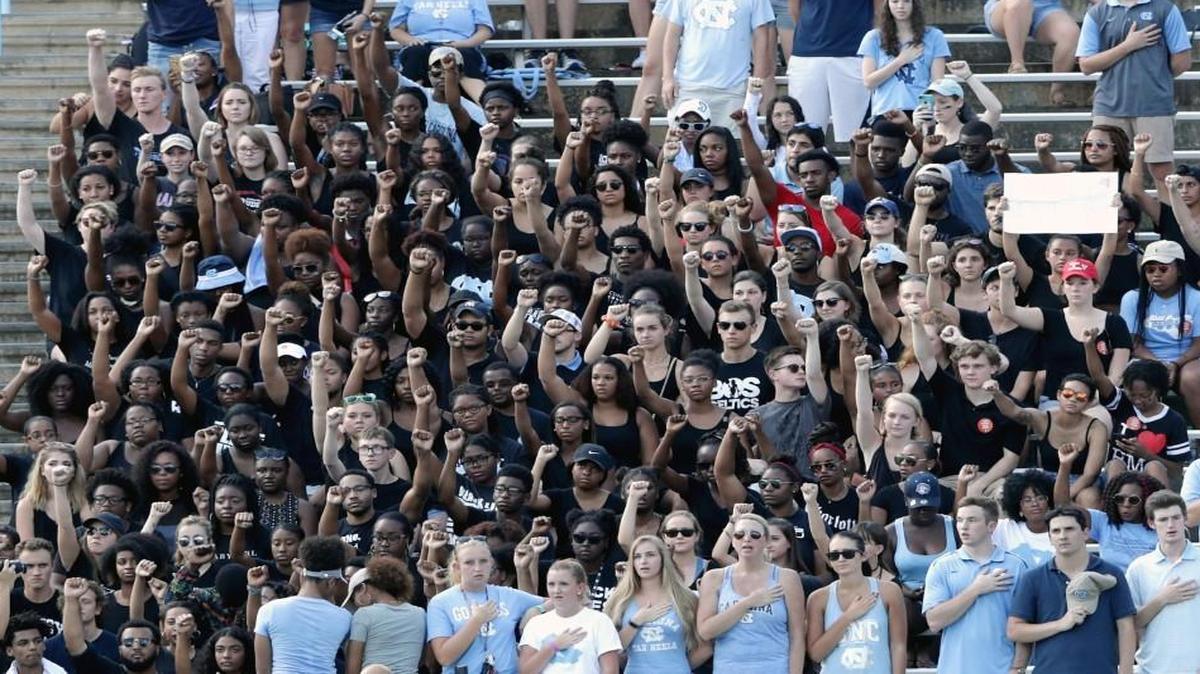 UNC students protest during the national anthem before the start of the Tar Heels’ game against Pittsburgh at Kenan Stadium in Chapel Hill.