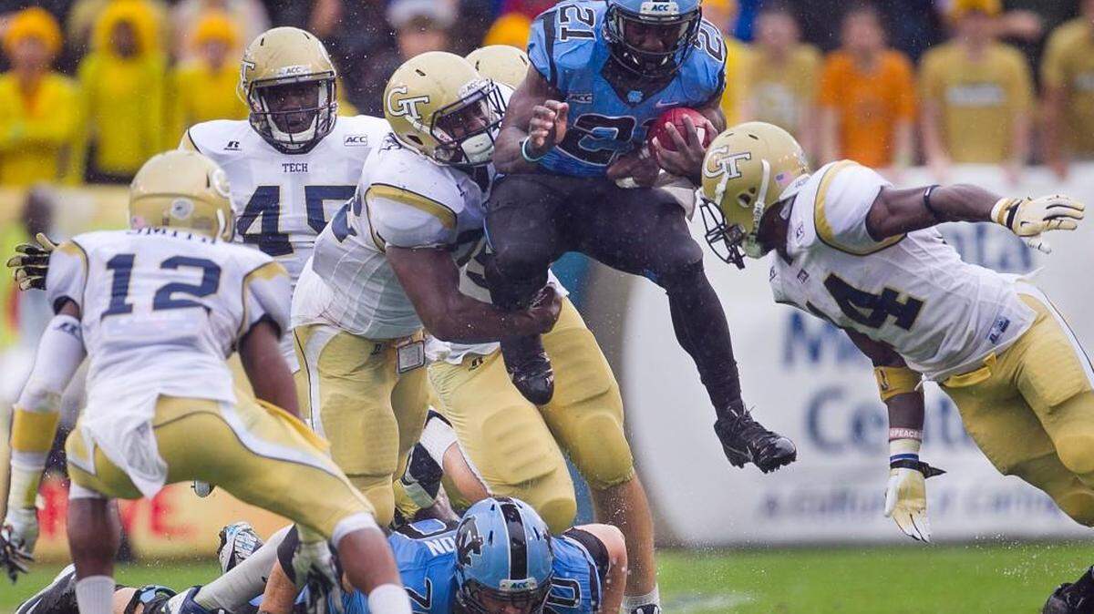 
Georgia Tech's Jabari Hunt-Days (32) and Jemea Thomas (14) stop UNC's Romar Morris (21) in 2013 at Bobby Dodd Stadium in Atlanta. UNC hasn’t beaten the Yellow Jackets in Atlanta since 1997. 


