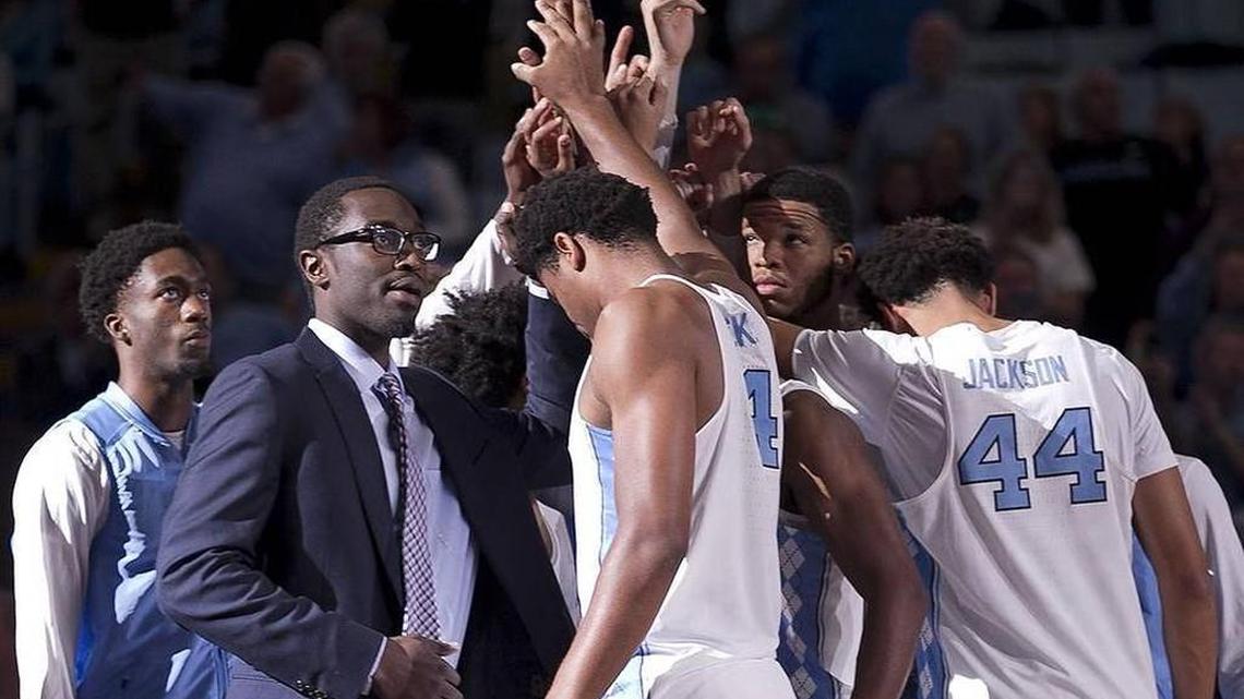 UNC junior forward Theo Pinson (left, in suit) joins his teammates before the Tar Heels’ 95-50 victory against Radford on Sunday. Pinson afterward expressed optimism about his return from a broken foot.